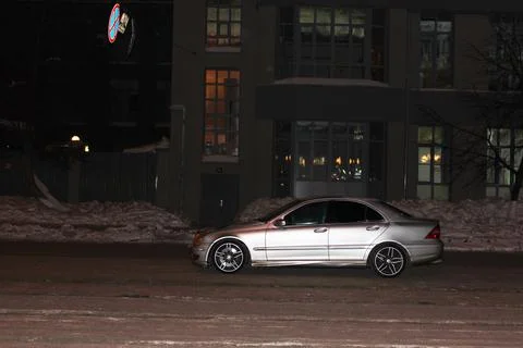 The car violates the parking rules. a silver car stands in the middle of the Stock Photos