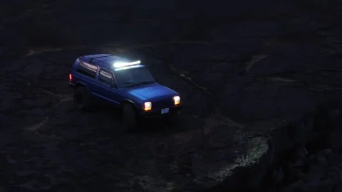 Car on Volcanic Rocks at Night Stock Footage 320700326