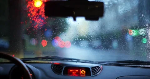 Car waiting at city red light on a rainy day with bokeh lights Stock Footage 338407742