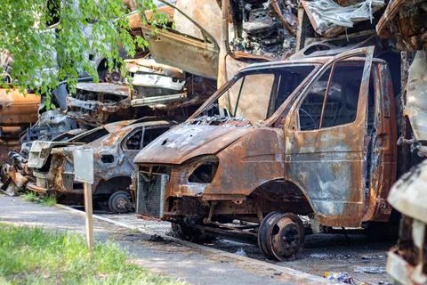 The car was completely destroyed by fire. Abandoned, burnt and rusty car by t Stock-Fotos