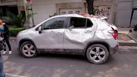 A car was smashed by the fall of building debris during the earthquake Stock Footage 80311222