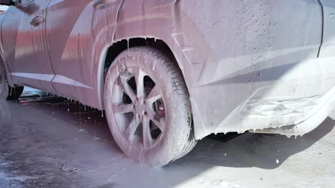 Car wash. Cleaning the car using high pressure water spraying. White soap foam. Stock Footage 245451412