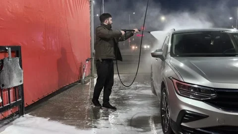 Car wash. Cleaning the car using high pressure water spraying. White soap foam. Stock Footage 271346315
