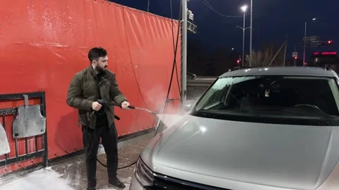Car wash. Cleaning the car using high pressure water spraying. White soap foam. Stock Footage 271346335