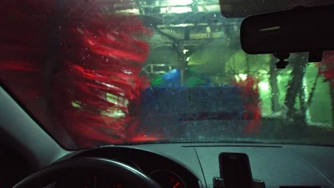 Car wash cleaning. Seen from inside a vehicle in 4K resolution Stock Footage 83692223