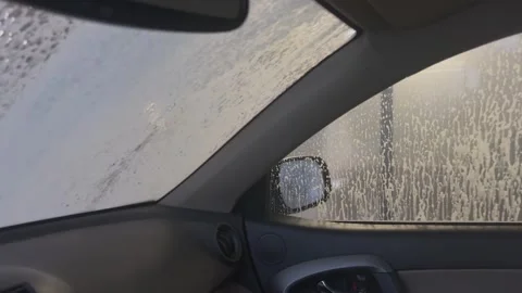 Car wash foam flowing on side window from inside view, Concept of vehicle Stock Footage 341866842