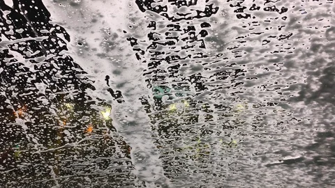 At the car wash foam flows down the glass Stock Footage 106780674