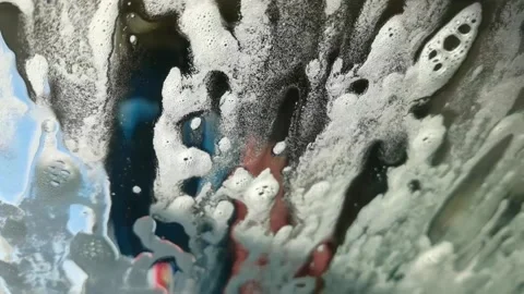 Car wash foam on the glass while brushes whashing Stock Footage 167680908