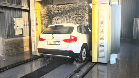Car wash process in a local facility using automated machines for cleaning vehic Stock Footage 327102178