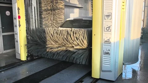 Car wash process in a local facility using automated machines for cleaning vehic Stock Footage 327102240