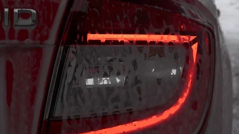 Car wash, rear view of the lantern, car in the cleaning foam Stock Footage 104876249