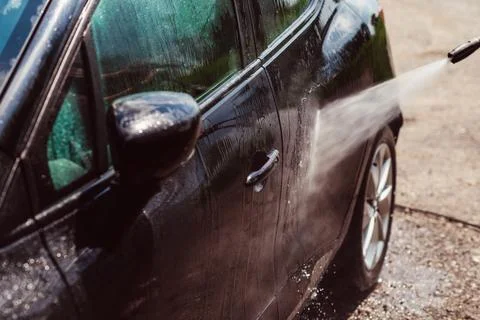 Car wash using high pressure water.  Power washing - cleaning concept. Foto stock