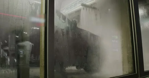 Car wash window view, water foam car wash, automatic car wash in action Stock Footage 246568321