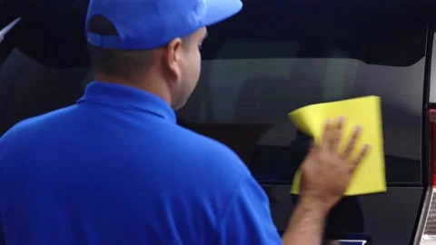 Car washers use a sponge to wipe the car glass with cleaning liquid to keep the  Video stock 152747870