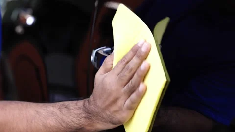 The car washers use a yellow sponge moistened with a car cleaner. Polished to th Stock Footage 152747899