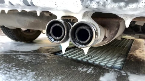 Car wash.exhaust pipe in foam Stock Footage 213532939