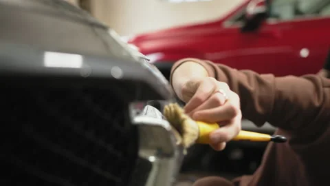Car washing, detailing concept. Side view of caucasian man worker of car wash Stock Footage 233777585