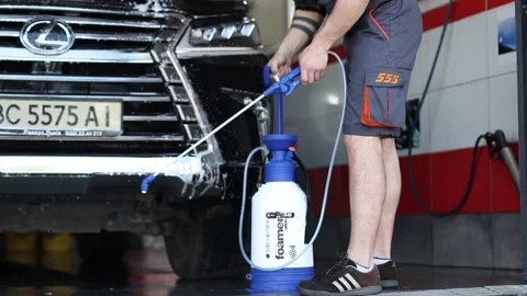 Car washing - the man holds the microfiber in hand and wash the car Stock Footage 143700853