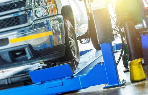 Car Wheel Alignment Check. Large Pickup Truck on the Alignment Equipment Stock Photos