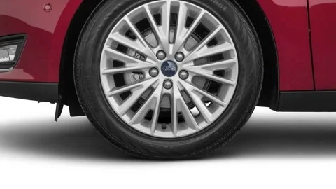 Car wheel close up side view Ruby Red Tinted Clearcoat 2016 Ford Focus Titanium Stock Footage 159587098