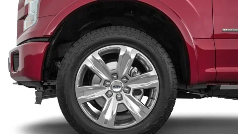 Car wheel close up side view Ruby Red Tinted Clearcoat 2016 Ford F-150 Platinum Stock Footage 159866631