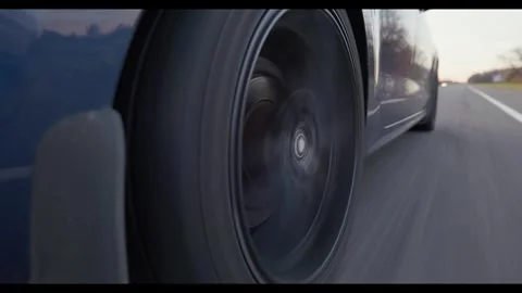Car wheel driving down the road during sunset Video stock 312625615