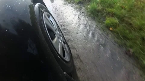 Car Wheel Driving Through Deep Puddle POV Stock Footage 82901396
