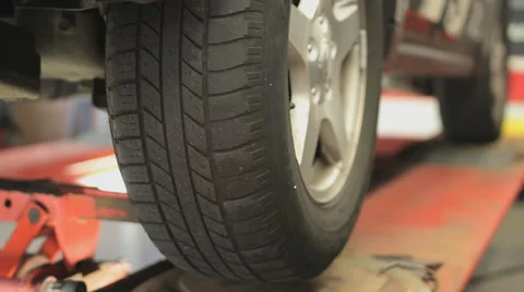 Car wheel fixed with computerized wheel alignment machine Stock Footage 51966628