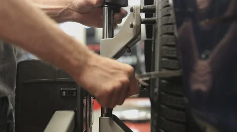 Car wheel fixed with computerized wheel alignment machine Stock Footage 51970228