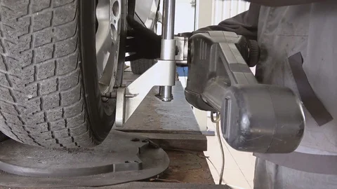 Car wheel fixed with computerized wheel alignment machine Stock Footage 98332465