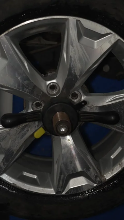 A car wheel mounted on a balancing machine in garage. Stock Footage 340977707