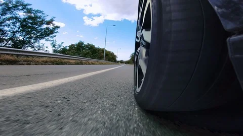 Car wheel spining while driving a car on a road Video stock 114578291