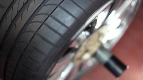 Car wheel spinning on balancing machine Stock Footage 49957652