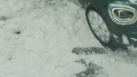 Car wheel spinning in deep snow during winter conditions, vehicle stuck in Stock Footage 342230951