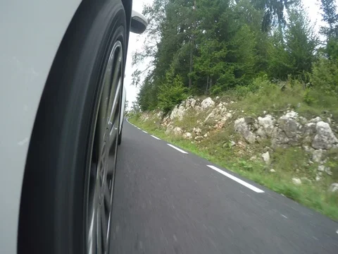 Car wheel spinning Point of View, day in mountain country side Stock Footage 72392735