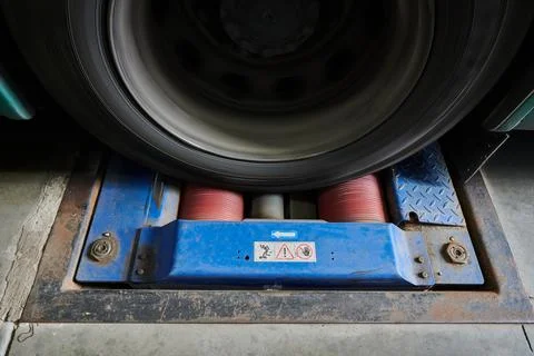 Car wheels on a power roller test bench during a bus brake system test Stock Photos