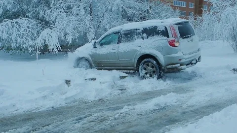 Car wheels riding on deep snow at winter season Stock Footage 77355373