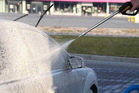 Car white active foam coating at car wash. Stock Photos