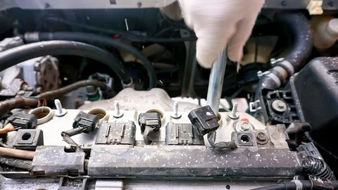 The car will not start, it's cold outside. A man unscrews a car engine spark Stock Footage 102896056