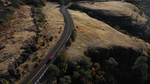 Car winding up road over a canyon in the desert Stock Footage 167106934