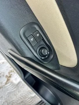 The car window and mirror adjustment control panel shows buttons and a dial.  Stock Photos
