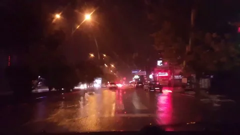 Car window rain night background defocused in motion Stock Footage 83876046