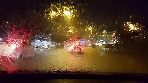 Car window rain night background defocused in motion Stock Footage 83876076