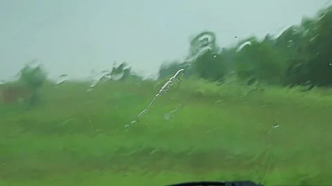 Car window Raining stormy day, rain drops flowing on window Video stock 76642351