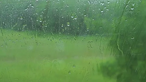 Car window Raining stormy day, rain drops flowing on window Video stock 76642823