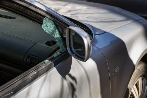 Car window smashed by a thief. Car broken window. Stock Photos