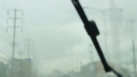 Car Window View of Driving in Heavy Rain with Windshield Wipers Stock Footage 339822853