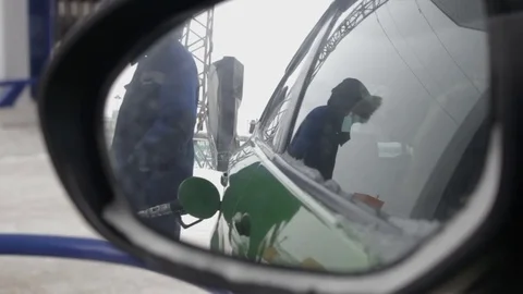 Car window view of man in work clothes refuel a car at petrol station Stock-Footage 71006686