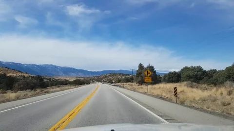 Car window view of snowy mountains, driving on route 395, on a sunny novemb.. Stock Footage 72411707