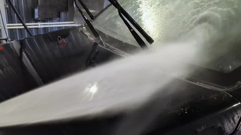 Car windshield cleaning process with wipers and water spray Stock Footage 335886260
